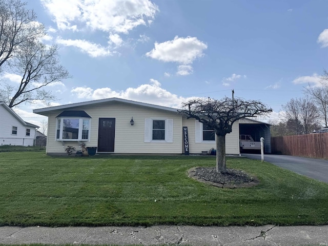 view of front facade featuring a carport, fence, and a front lawn
