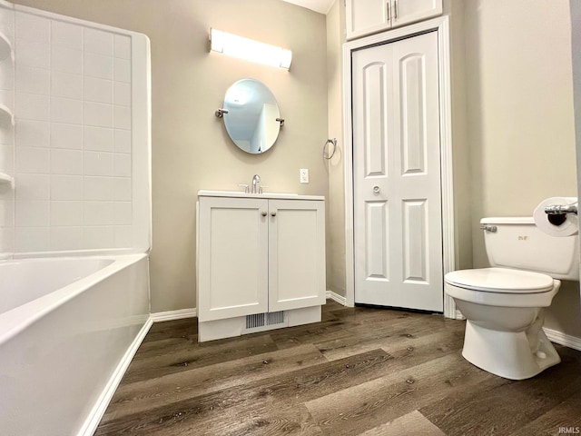 bathroom with vanity, baseboards, toilet, and wood finished floors