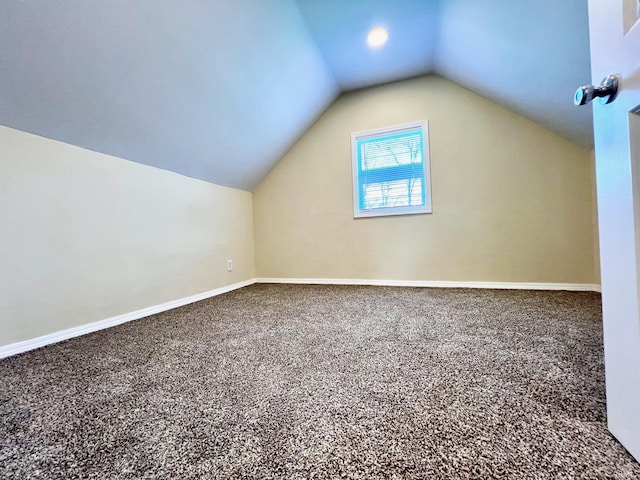 bonus room featuring baseboards, carpet flooring, and lofted ceiling
