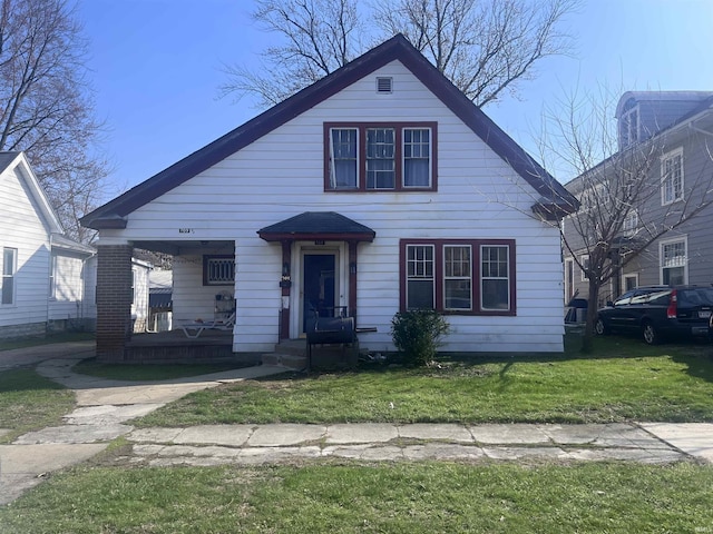 bungalow-style house with a front lawn