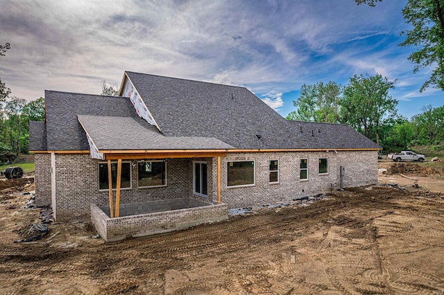 4092 Cottonwood Dr, Victoria Woods, IN 47601 - back of house featuring brick siding, a patio, and roof with shingles