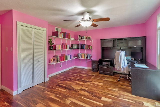 office area with visible vents, ceiling fan, wood finished floors, and baseboards