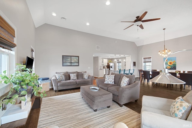 617 Pearl St, Culver, IN 46511 - living room with light wood-style flooring, ceiling fan with notable chandelier, high vaulted ceiling, and visible vents