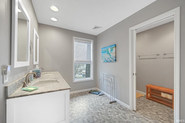617 Pearl St, Culver, IN 46511 - bathroom with visible vents, baseboards, a sink, double vanity, and recessed lighting