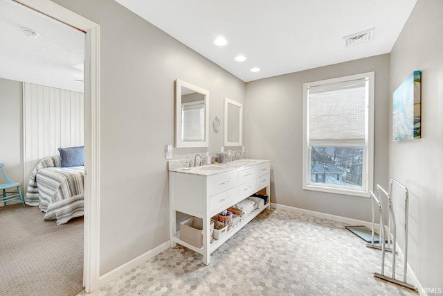 617 Pearl St, Culver, IN 46511 - ensuite bathroom featuring ensuite bath, visible vents, baseboards, and double vanity