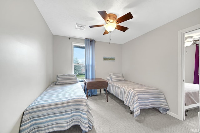 617 Pearl St, Culver, IN 46511 - bedroom with visible vents, baseboards, ceiling fan, and carpet
