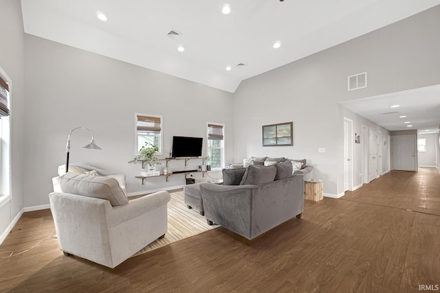617 Pearl St, Culver, IN 46511 - living room with high vaulted ceiling, baseboards, dark wood-style floors, and visible vents