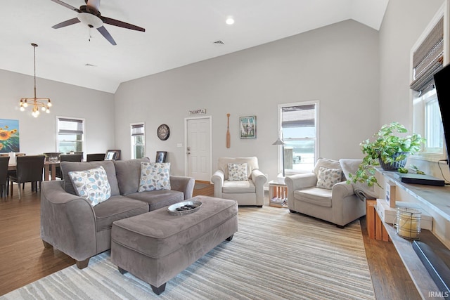 617 Pearl St, Culver, IN 46511 - living room featuring high vaulted ceiling, visible vents, ceiling fan with notable chandelier, and wood finished floors