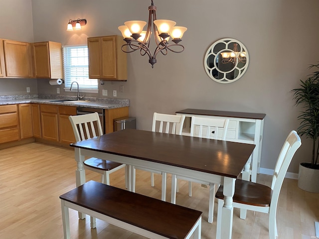 dining space featuring a chandelier and light wood finished floors