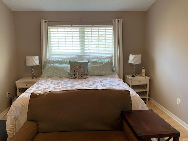 bedroom with multiple windows and baseboards