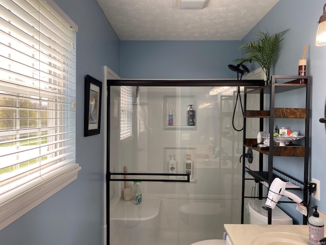 bathroom with toilet, a stall shower, vanity, and plenty of natural light