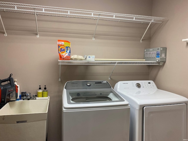laundry area with washer and dryer, laundry area, and a sink