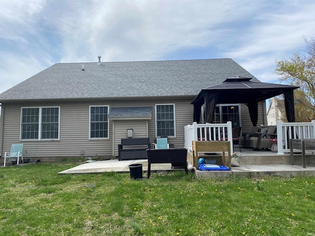 rear view of property with outdoor lounge area, a lawn, a patio area, a gazebo, and a shingled roof