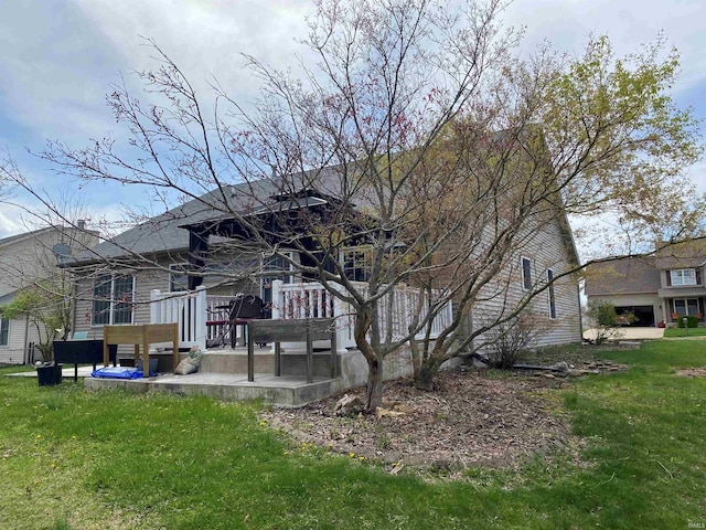 rear view of property with a patio, a yard, and a deck