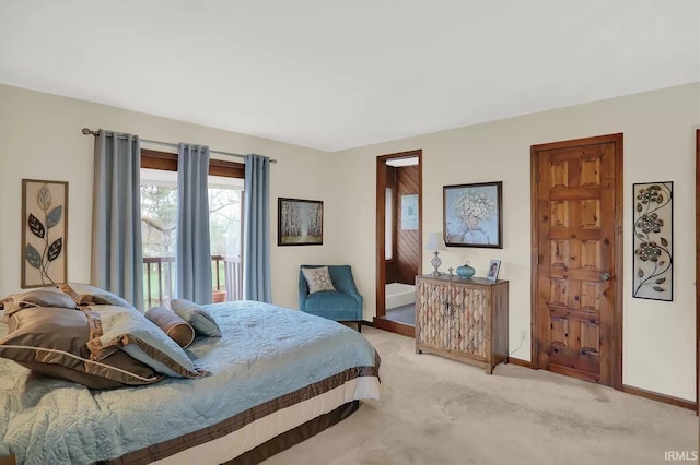 bedroom with baseboards and light colored carpet
