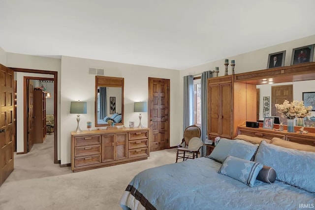 bedroom with light carpet and visible vents