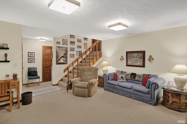 carpeted living area featuring a textured ceiling and stairs