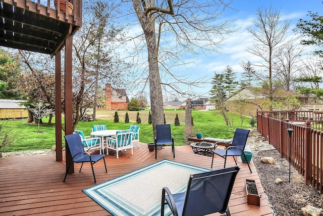 deck featuring a yard, outdoor dining area, and an outdoor fire pit