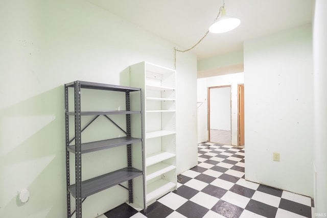 hall with tile patterned floors
