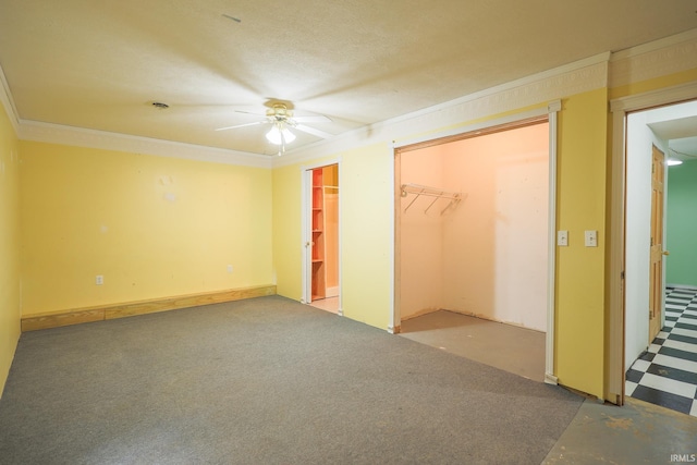 unfurnished bedroom with crown molding, two closets, a ceiling fan, and carpet floors