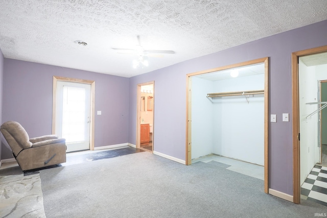 unfurnished room featuring carpet, a textured ceiling, and ceiling fan