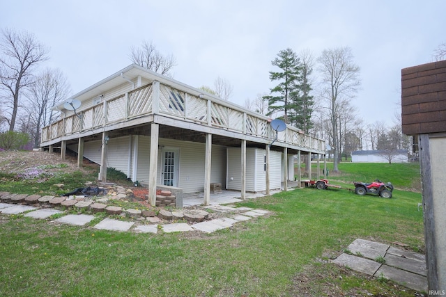 rear view of house featuring a yard and a wooden deck