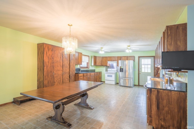 dining area with baseboards, light floors, and ceiling fan with notable chandelier