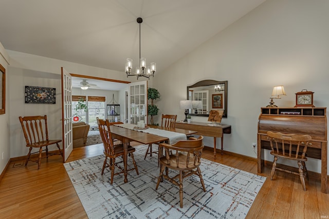 379 Pleasant View Dr, Evansville, IN 47711 - dining area with light wood-style flooring, an inviting chandelier, baseboards, and lofted ceiling