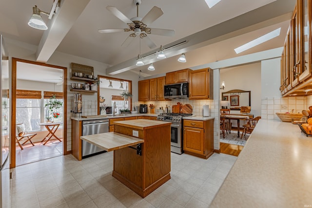 379 Pleasant View Dr, Evansville, IN 47711 - kitchen with butcher block counters, appliances with stainless steel finishes, decorative backsplash, and a center island