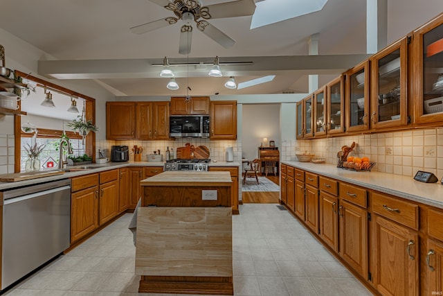 379 Pleasant View Dr, Evansville, IN 47711 - kitchen featuring a skylight, light countertops, a kitchen island, ceiling fan, and stainless steel appliances