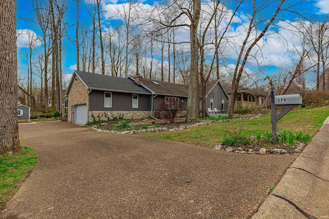 379 Pleasant View Dr, Evansville, IN 47711 - ranch-style house with a garage, aphalt driveway, stone siding, and a chimney