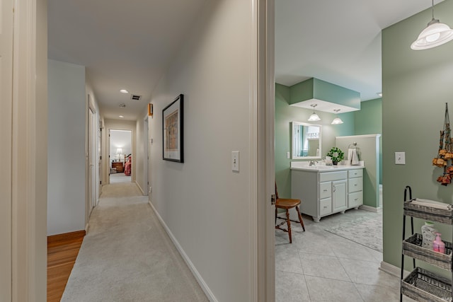 379 Pleasant View Dr, Evansville, IN 47711 - hallway with visible vents, a sink, baseboards, and recessed lighting