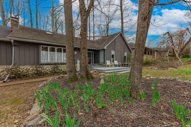 379 Pleasant View Dr, Evansville, IN 47711 - exterior space featuring a patio area, roof with shingles, board and batten siding, and a chimney