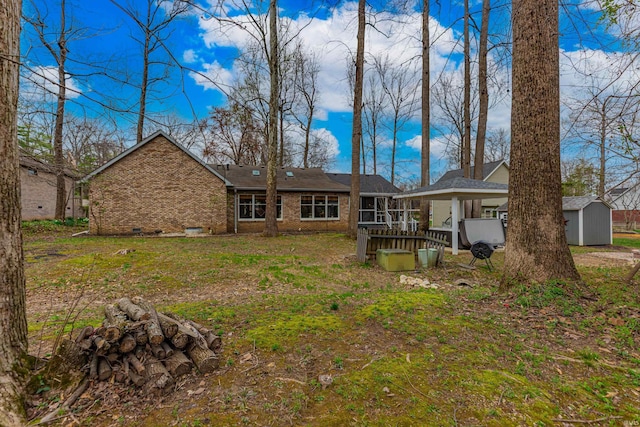 379 Pleasant View Dr, Evansville, IN 47711 - rear view of property with a storage shed, a carport, crawl space, an outdoor structure, and brick siding