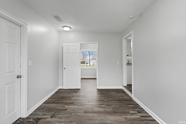 11314 NE Wawasee Dr, Syracuse, IN 46567 - hallway with dark wood-type flooring, visible vents, baseboards, and a textured ceiling