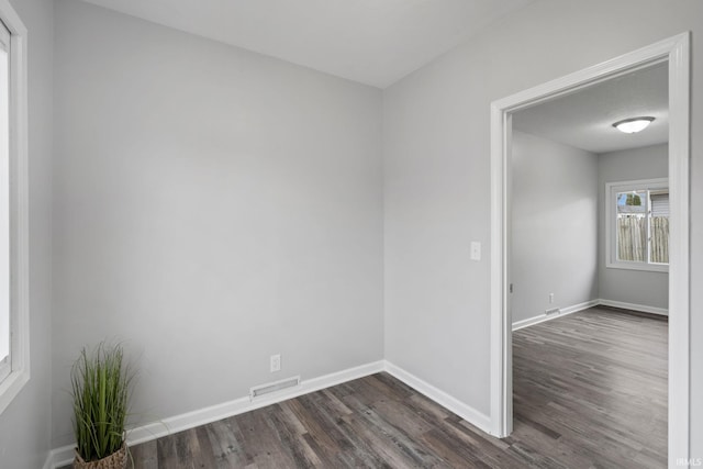 11314 NE Wawasee Dr, Syracuse, IN 46567 - spare room featuring visible vents, baseboards, and dark wood finished floors