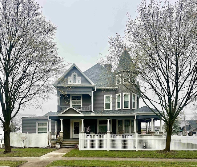 328 W Market St, Bluffton, IN 46714 - victorian house featuring a porch, a chimney, and a fenced front yard