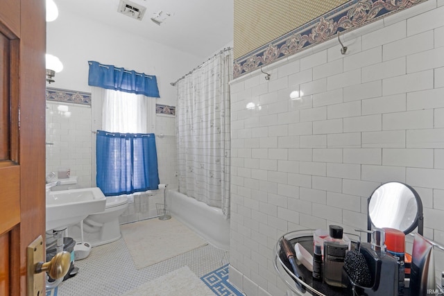 328 W Market St, Bluffton, IN 46714 - bathroom featuring tile patterned floors, shower / bath combo, toilet, tile walls, and visible vents