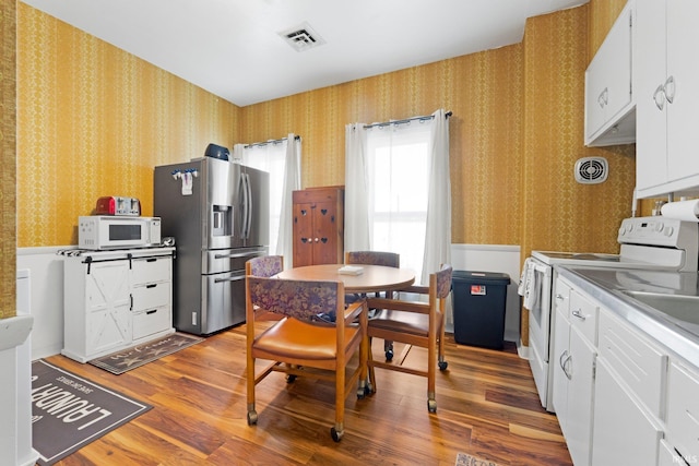 328 W Market St, Bluffton, IN 46714 - kitchen with wallpapered walls, wood finished floors, and white appliances