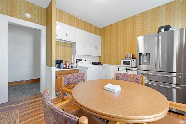 328 W Market St, Bluffton, IN 46714 - kitchen featuring wood finished floors, wallpapered walls, separate washer and dryer, stainless steel fridge with ice dispenser, and white microwave