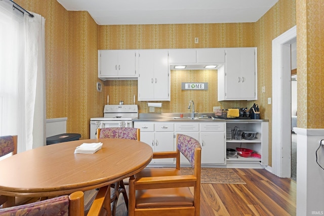 328 W Market St, Bluffton, IN 46714 - kitchen with stainless steel counters, a sink, wallpapered walls, wood finished floors, and white range with electric cooktop