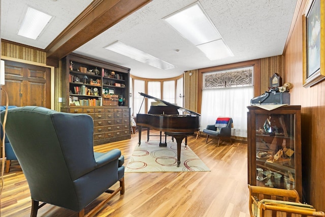 328 W Market St, Bluffton, IN 46714 - living area with wood walls, wood finished floors, and a textured ceiling