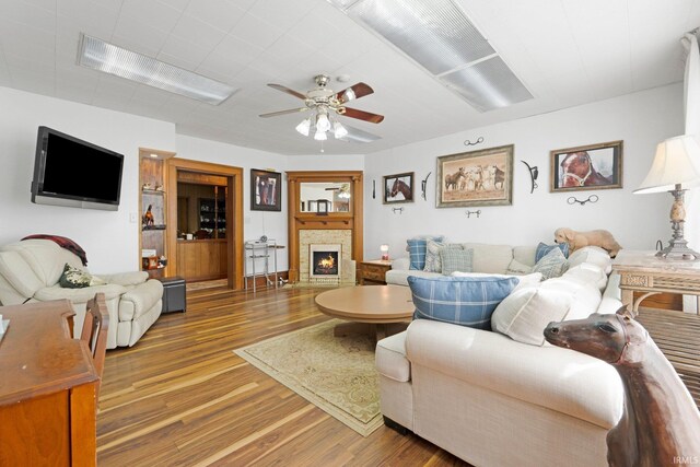 328 W Market St, Bluffton, IN 46714 - living room with a warm lit fireplace, wood finished floors, and ceiling fan