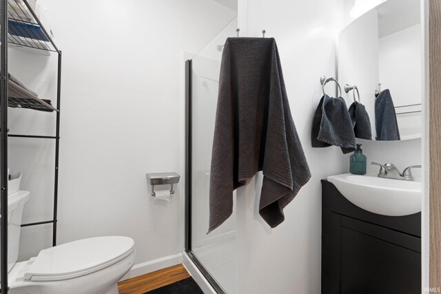 328 W Market St, Bluffton, IN 46714 - full bathroom featuring toilet, a stall shower, baseboards, wood finished floors, and vanity