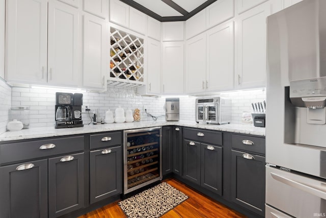 328 W Market St, Bluffton, IN 46714 - bar featuring stainless steel refrigerator with ice dispenser, dark wood-style floors, decorative backsplash, and wine cooler