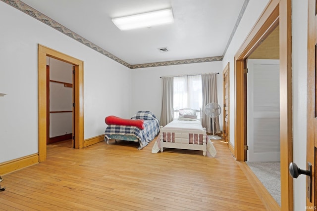 328 W Market St, Bluffton, IN 46714 - bedroom featuring wood-type flooring, baseboards, and visible vents