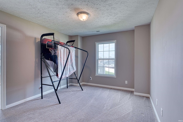 9919 Blyth Dr, Evansville, IN 47725 - workout area with visible vents, baseboards, a textured ceiling, and carpet floors