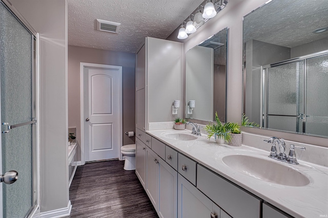 9919 Blyth Dr, Evansville, IN 47725 - full bathroom featuring a textured ceiling, wood finished floors, a sink, and visible vents