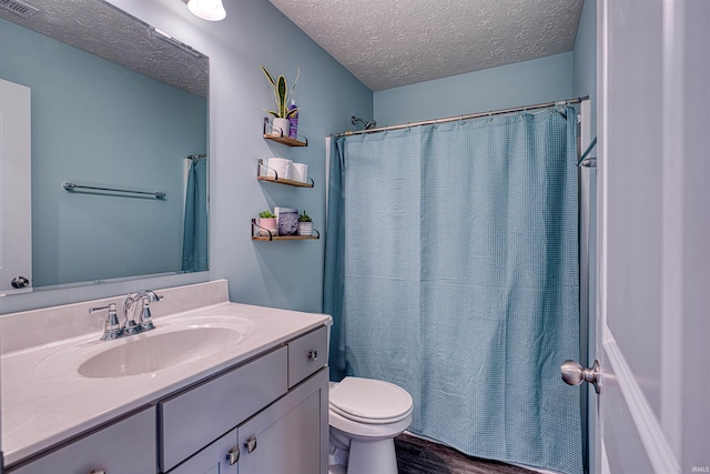 9919 Blyth Dr, Evansville, IN 47725 - full bath with visible vents, toilet, a textured ceiling, vanity, and wood finished floors