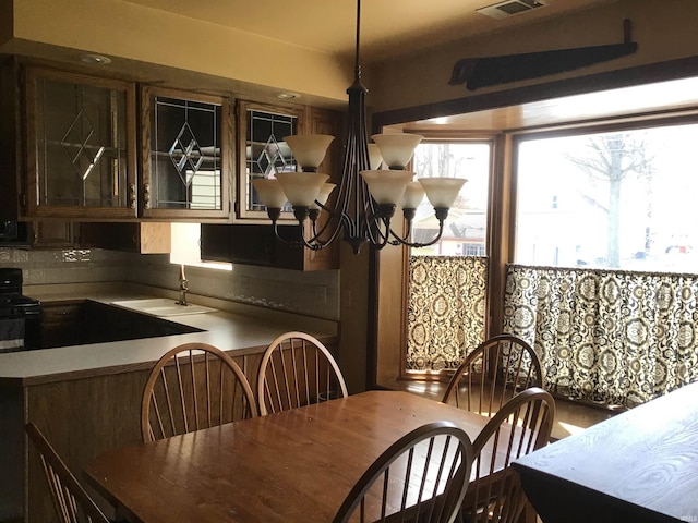dining area featuring an inviting chandelier and visible vents